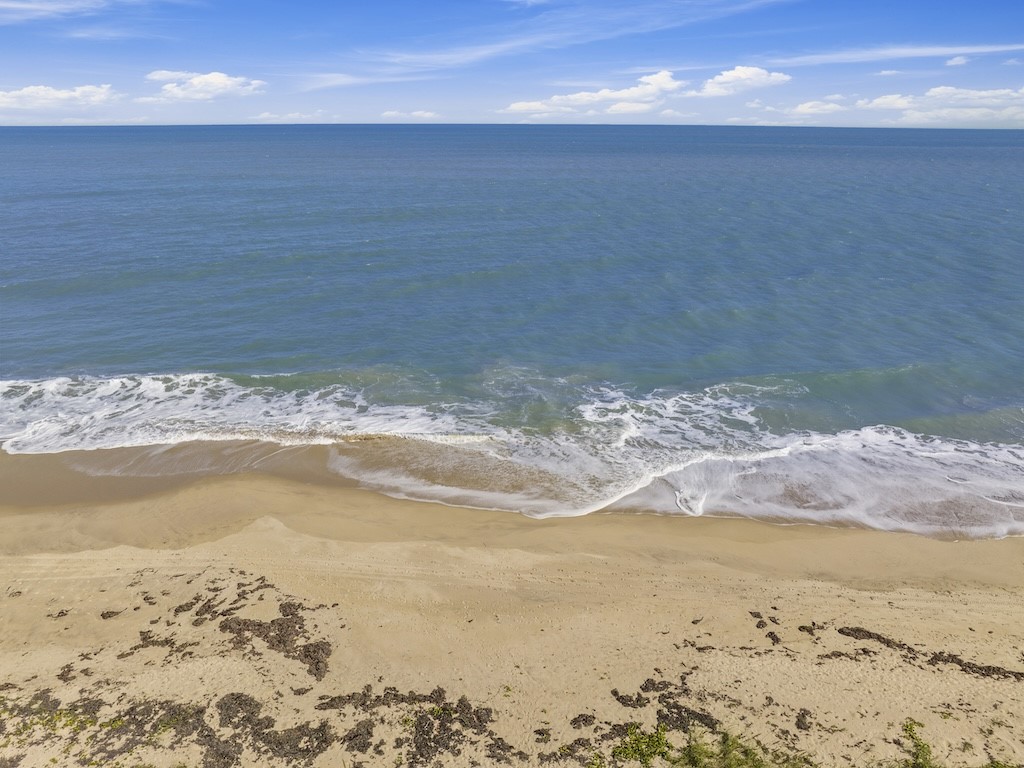 1180 Reef Road, Unit A24 Vero Beach, FL 32963 - Photo 23 of 26 a view of beach and ocean