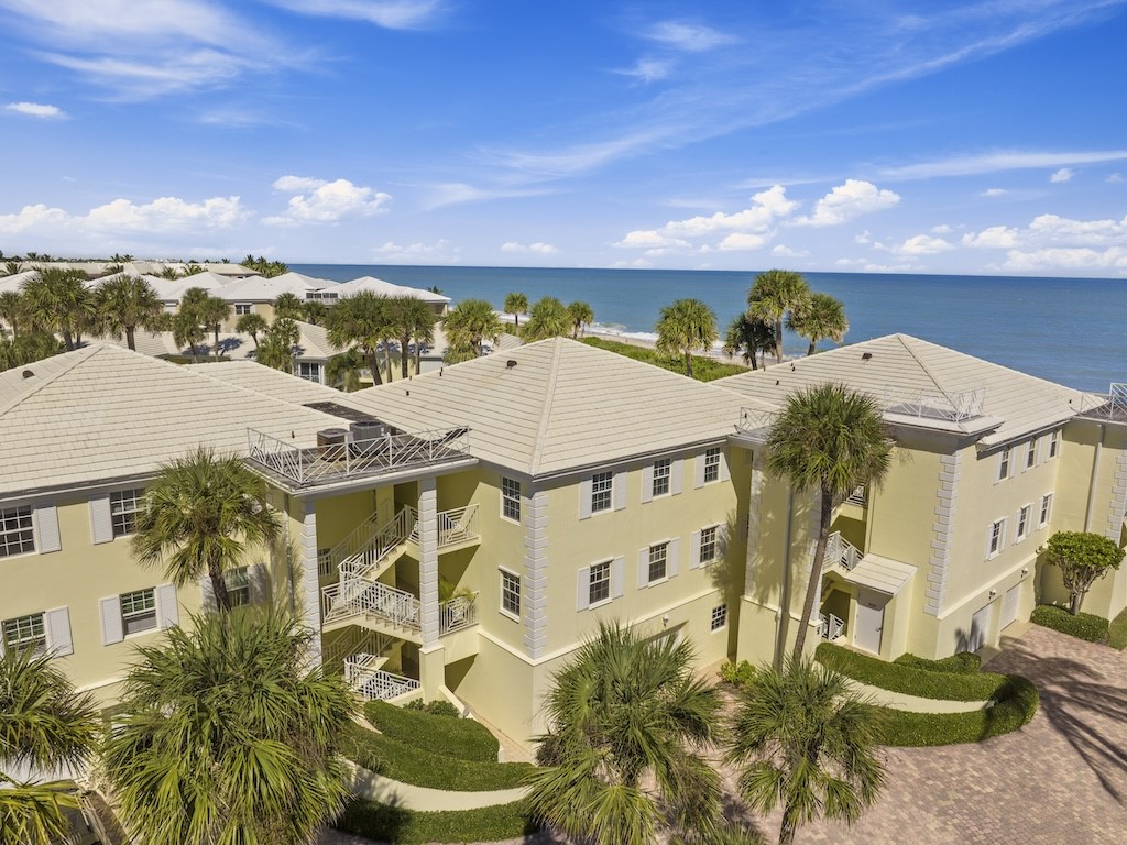 1180 Reef Road, Unit A24 Vero Beach, FL 32963 - Photo 25 of 26 a view of a building with a yard