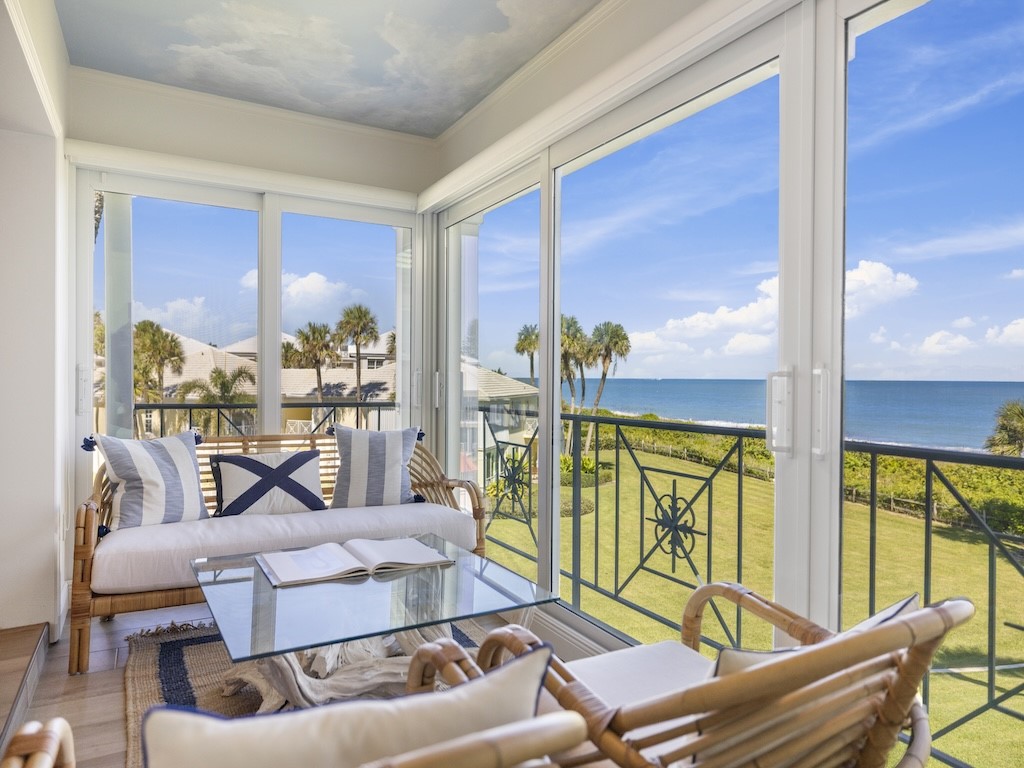 1180 Reef Road, Unit A24 Vero Beach, FL 32963 - Photo 3 of 26 a living room with furniture and a large window