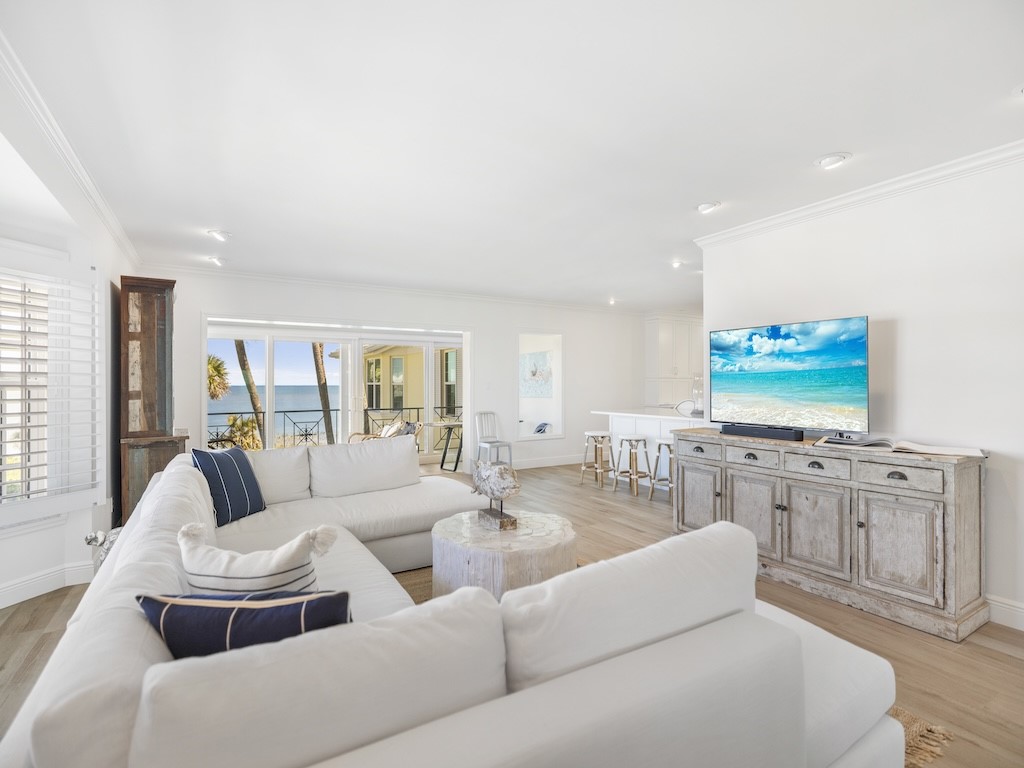 1180 Reef Road, Unit A24 Vero Beach, FL 32963 - Photo 4 of 26 a living room with furniture and a flat screen tv