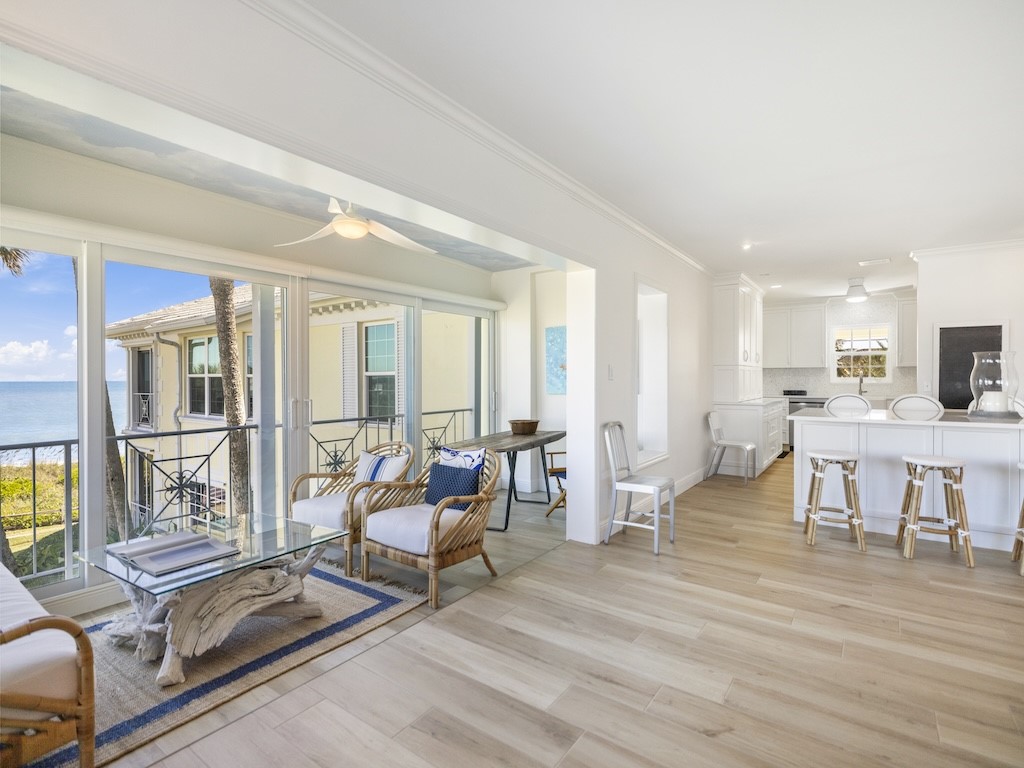 1180 Reef Road, Unit A24 Vero Beach, FL 32963 - Photo 5 of 26 a living room with furniture and a dining table with kitchen view