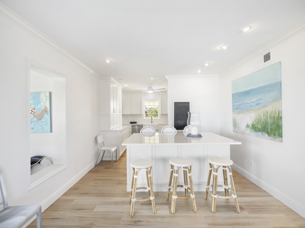 1180 Reef Road, Unit A24 Vero Beach, FL 32963 - Photo 6 of 26 a view of a dining room with furniture and wooden floor