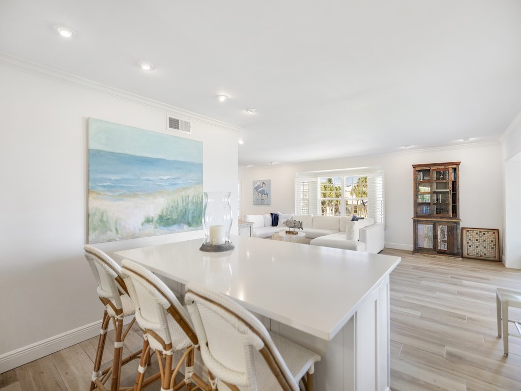 1180 Reef Road, Unit A24 Vero Beach, FL 32963 - Photo 7 of 26 a view of a dining room with furniture and wooden floor
