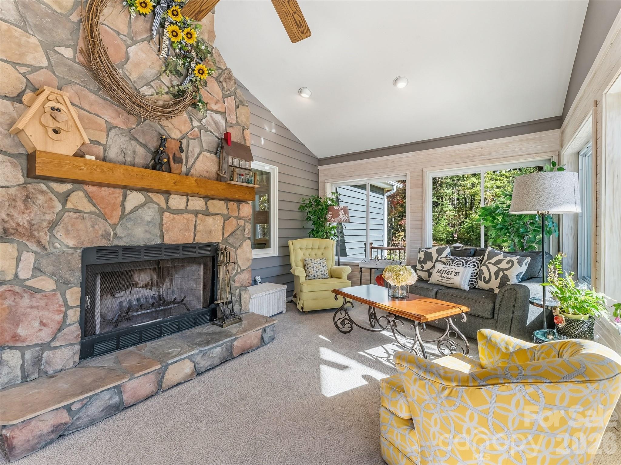 1340 Macedonia Road Saluda, NC 28773 - Photo 20 of 45 a living room with furniture and a fireplace