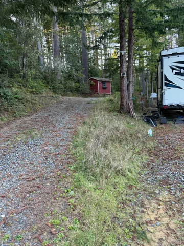 a backyard of a house with wooden floor and fence