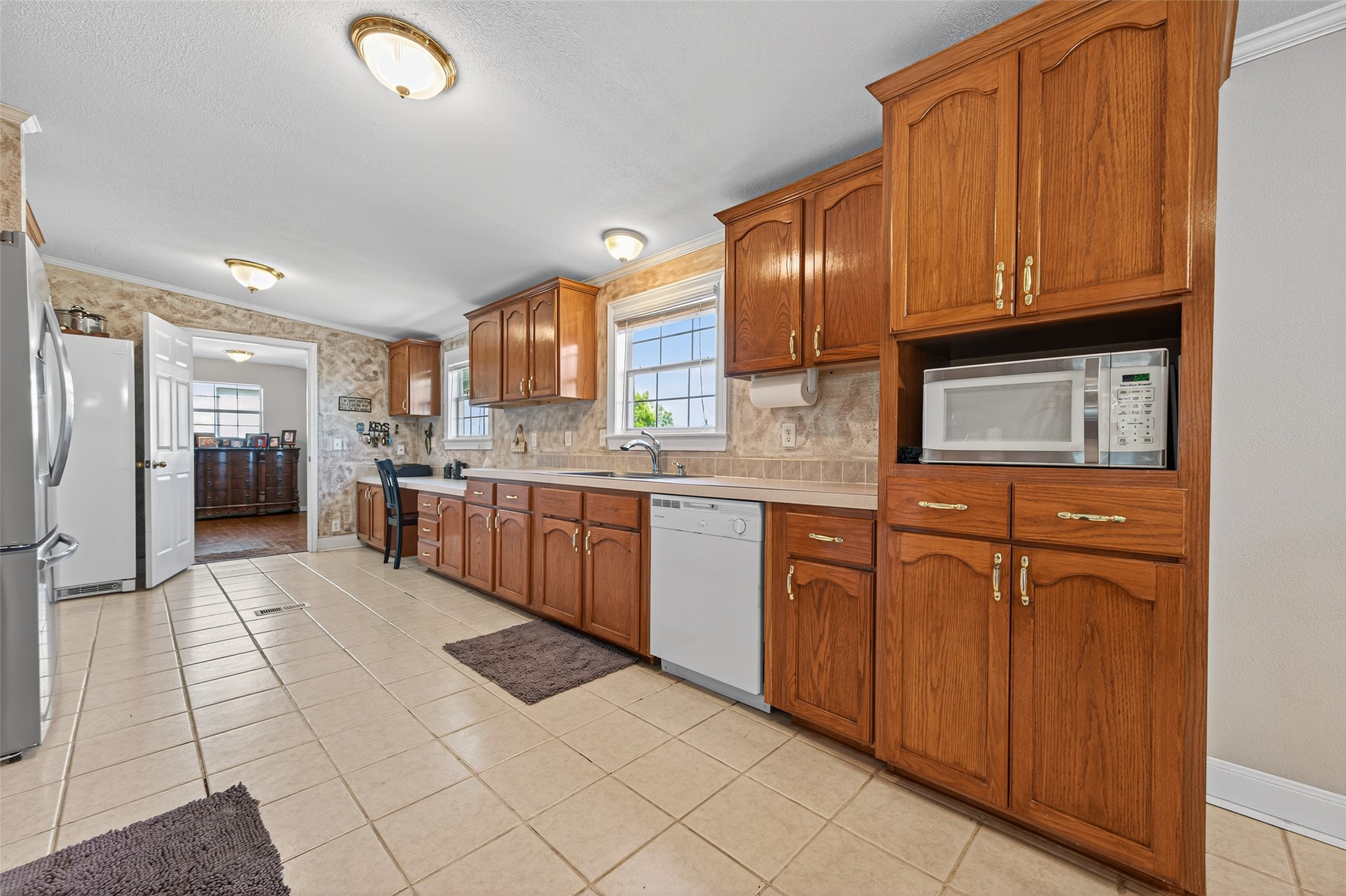 32445 Knebel Road Waller, TX 77484 - Photo 23 of 49 a kitchen with stainless steel appliances granite countertop a stove top oven a sink dishwasher and cabinets with wooden floor