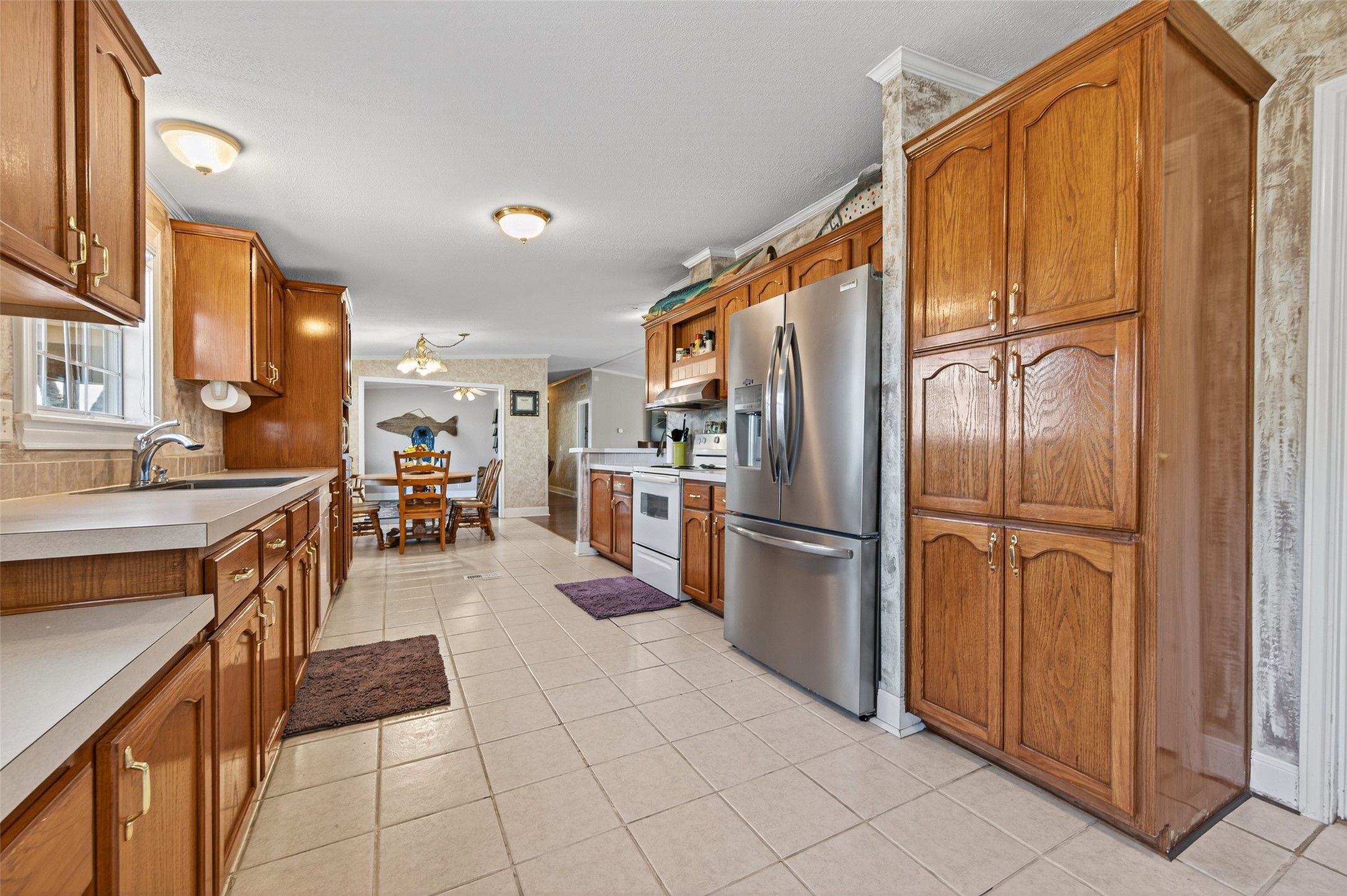 32445 Knebel Road Waller, TX 77484 - Photo 25 of 49 a kitchen with stainless steel appliances a refrigerator and a stove top oven