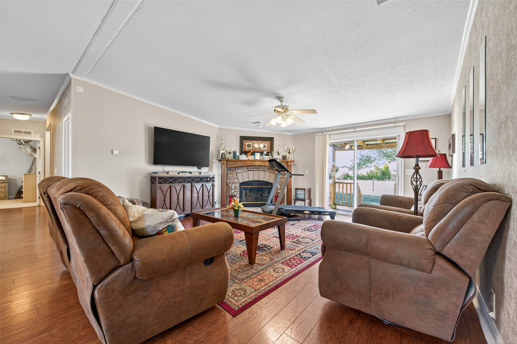 32445 Knebel Road Waller, TX 77484 - Photo 29 of 49 a living room with furniture a fireplace and a flat screen tv