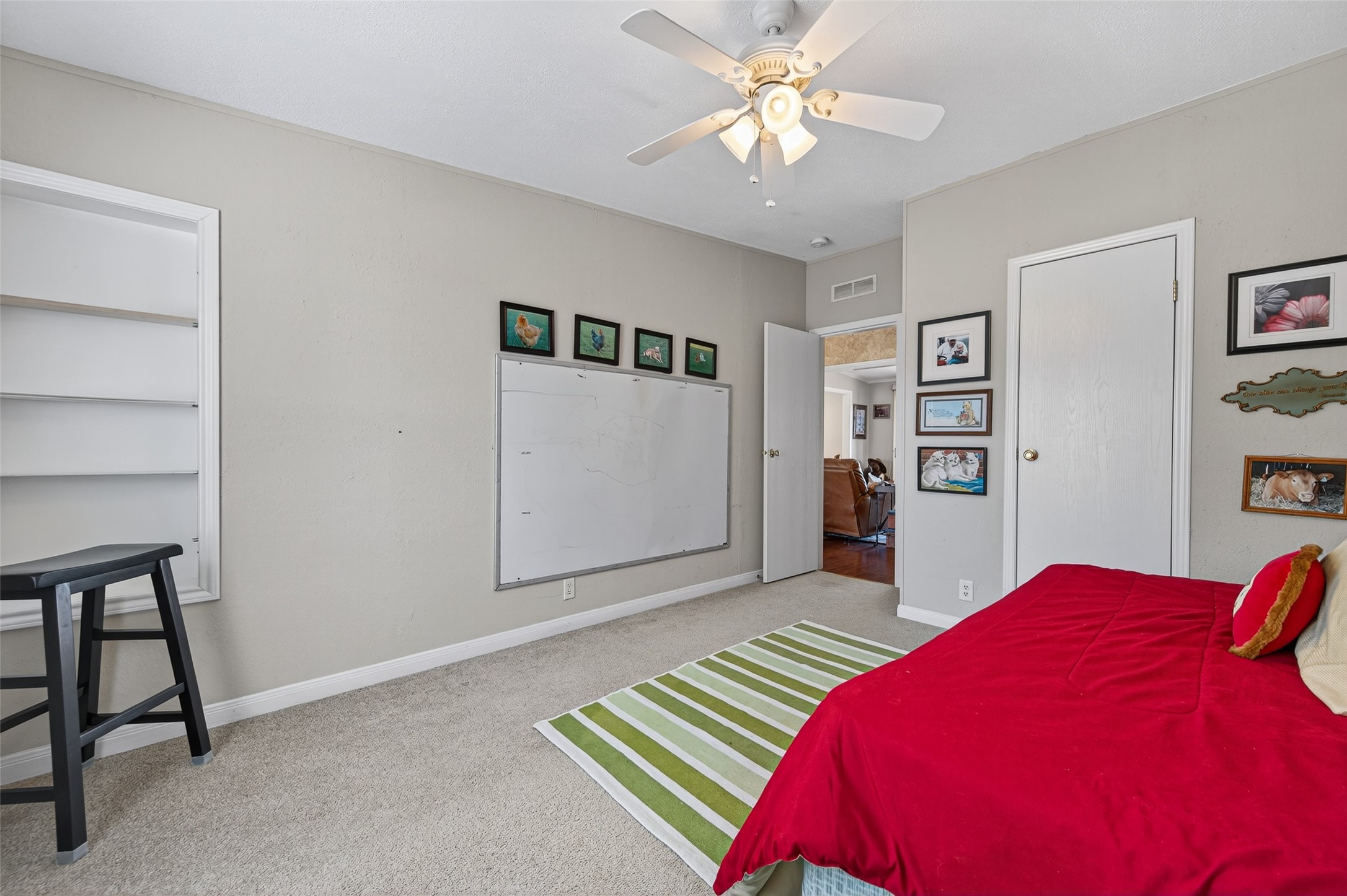 32445 Knebel Road Waller, TX 77484 - Photo 34 of 49 a bedroom with a bed and a chandelier