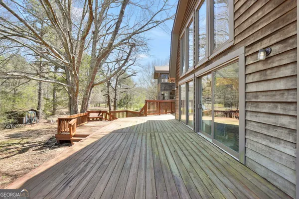 a front view of a house with a yard covered with snow