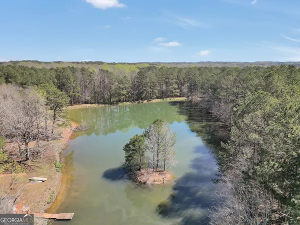 a living room with furniture a fireplace and a large window