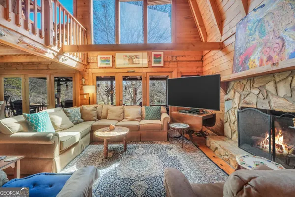 a kitchen with stainless steel appliances granite countertop a refrigerator a sink dishwasher a stove and white countertops with wooden floor