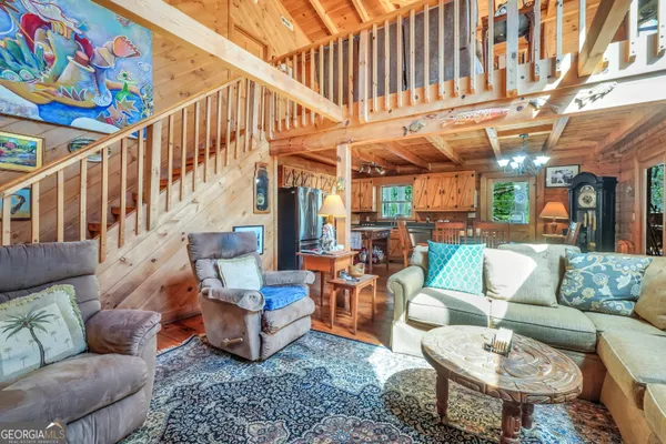 a view of a dining room with furniture a chandelier and wooden floor