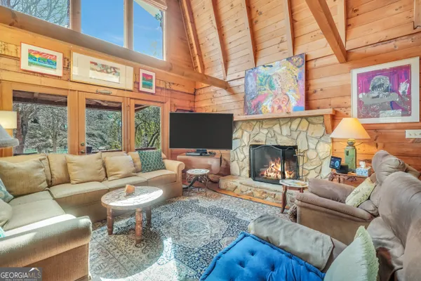 a open kitchen with stainless steel appliances granite countertop a stove a refrigerator a dining table and chairs with wooden floor