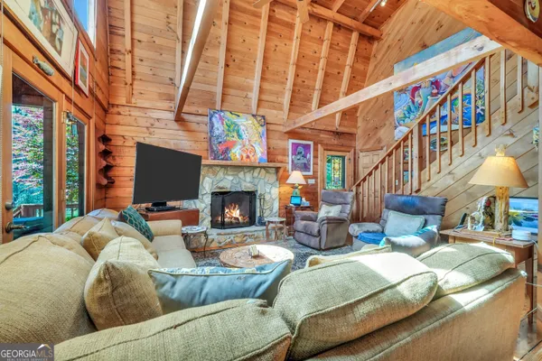 a kitchen with stainless steel appliances granite countertop a refrigerator a sink dishwasher a stove and white countertops with wooden floor