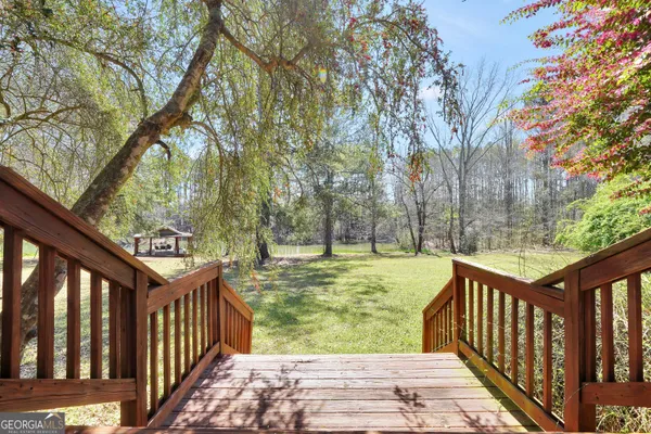 a spacious bedroom with a bed and wooden floor
