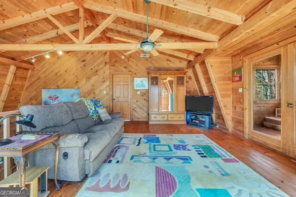 a bed room with a bed and a painting on the wall