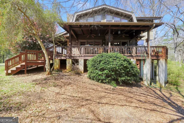 a view of yard with swimming pool and trees in the background
