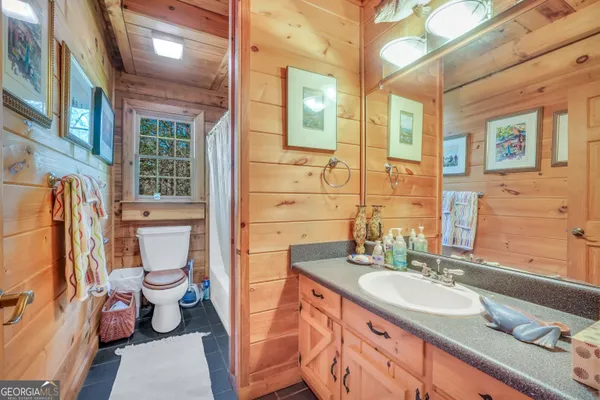 a patio with lawn chairs and wooden floor