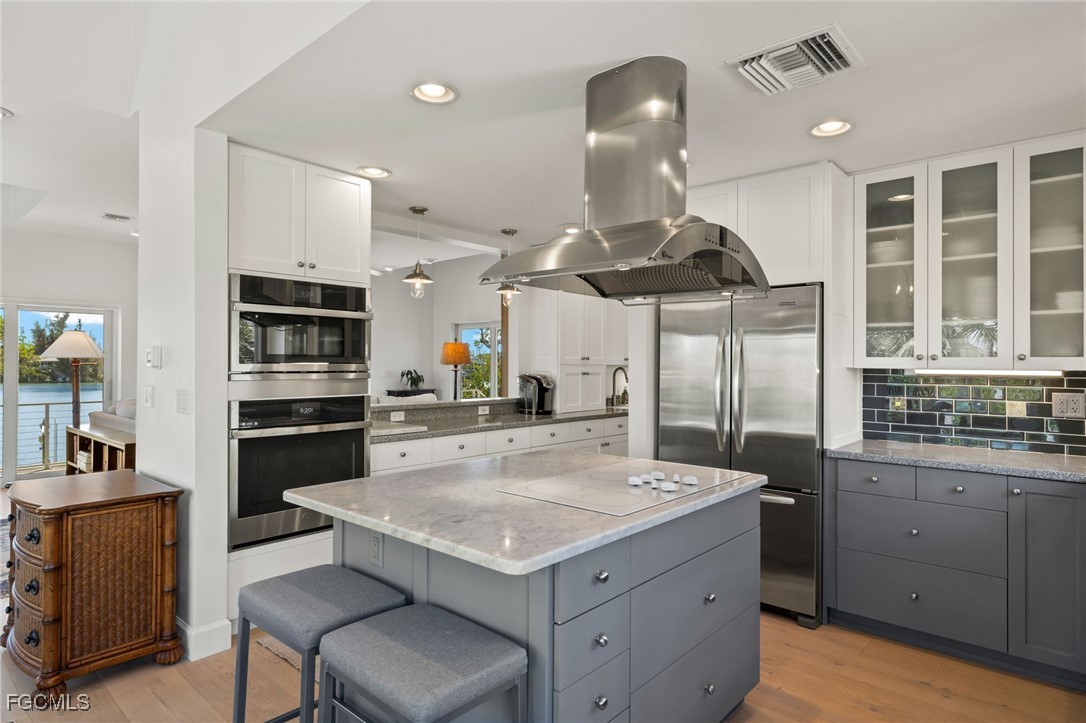 2400 Los Colony Road Sanibel, FL 33957 - Photo 11 of 50 a kitchen with a stove a refrigerator and a sink