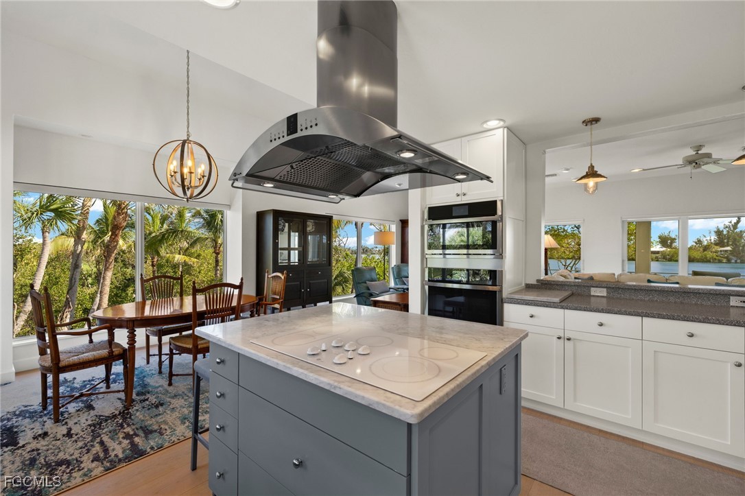 2400 Los Colony Road Sanibel, FL 33957 - Photo 12 of 50 a kitchen with a table and chairs in it