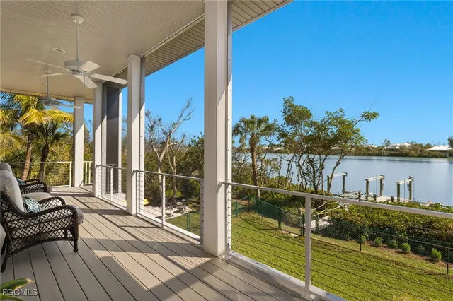 a view of a balcony with dining table & chairs