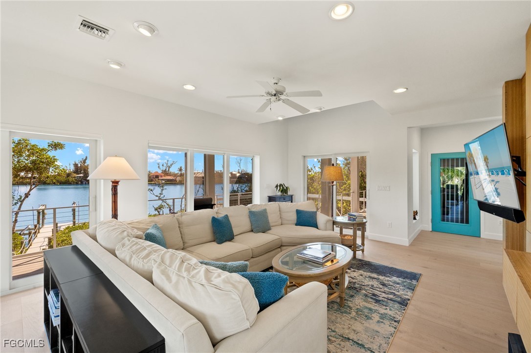 2400 Los Colony Road Sanibel, FL 33957 - Photo 19 of 50 a living room with furniture and a fireplace