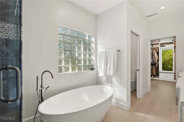 a bathroom with a toilet and a shower