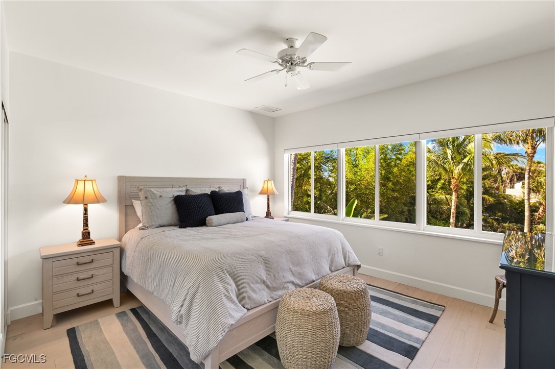 2400 Los Colony Road Sanibel, FL 33957 - Photo 27 of 50 a bedroom with a bed and a large window with outer view