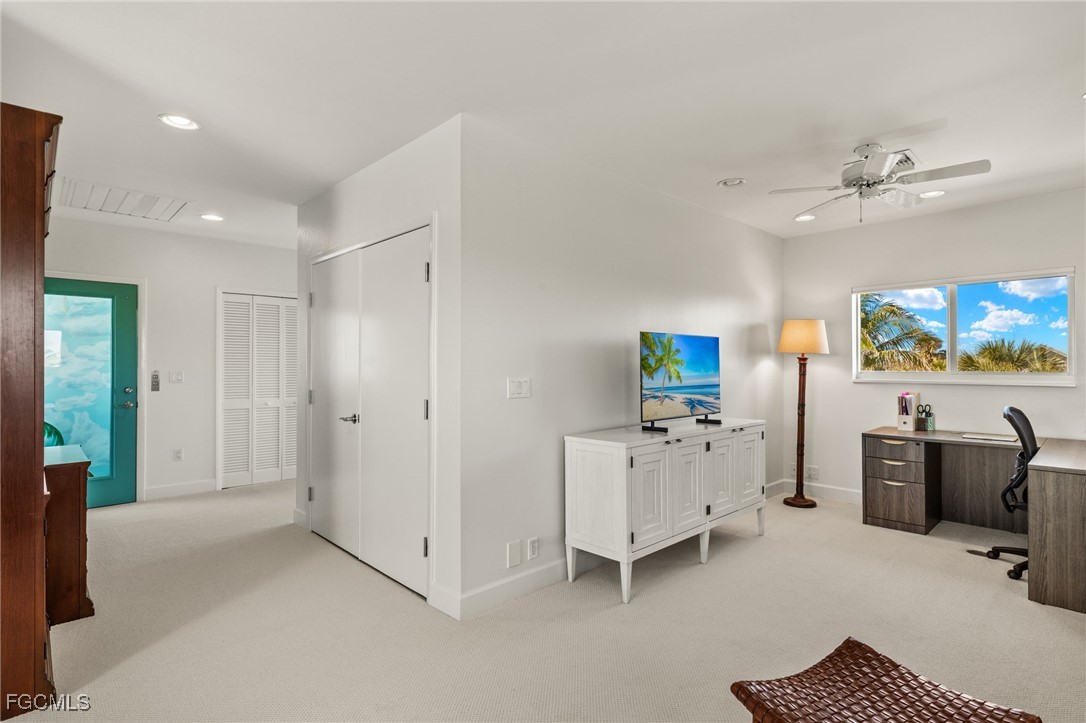 2400 Los Colony Road Sanibel, FL 33957 - Photo 31 of 50 a view of a workspace with furniture and a flat screen tv