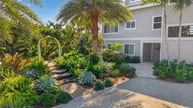 a front view of a house with a yard and a garage