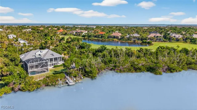 an aerial view of a house with a yard and swimming pool