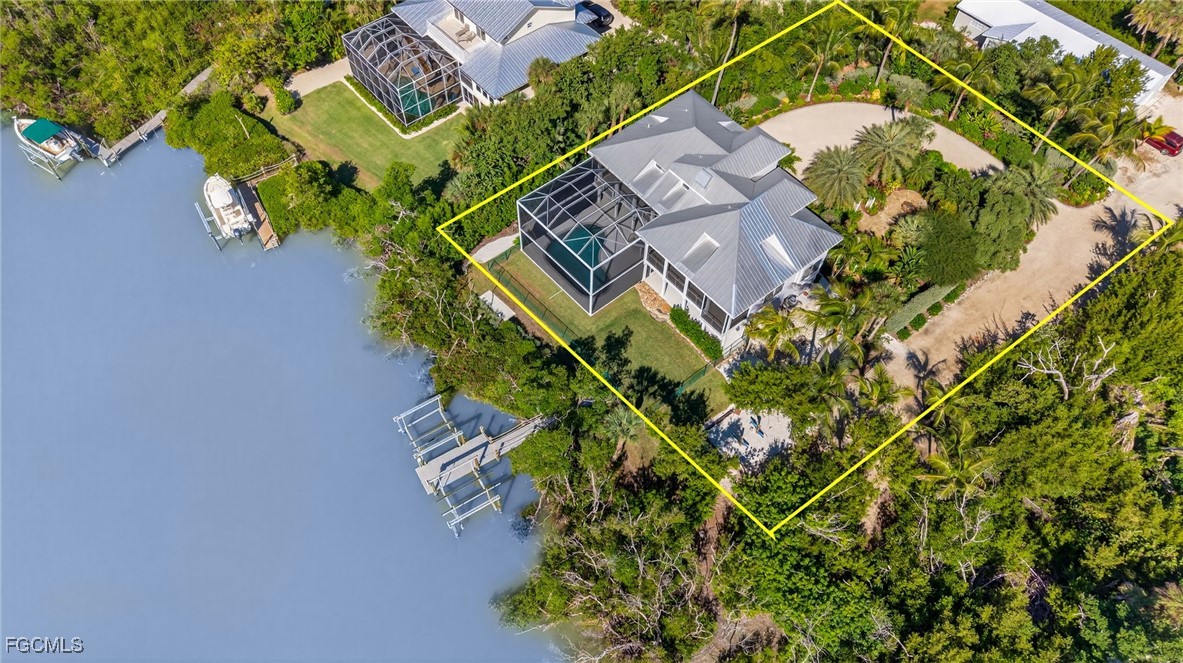 2400 Los Colony Road Sanibel, FL 33957 - Photo 47 of 50 an aerial view of a house with a yard and swimming pool