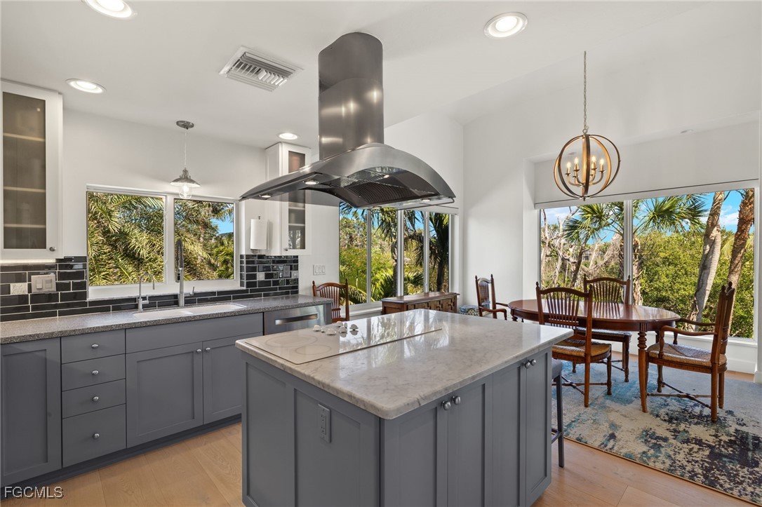 2400 Los Colony Road Sanibel, FL 33957 - Photo 7 of 50 a kitchen with stainless steel appliances granite countertop a sink a stove and a dining table with chairs
