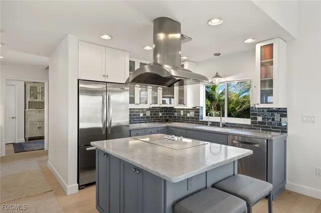 a kitchen with a sink a stove and a refrigerator
