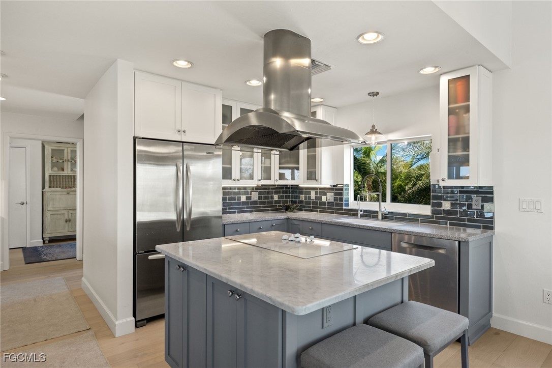 2400 Los Colony Road Sanibel, FL 33957 - Photo 8 of 50 a kitchen with stainless steel appliances granite countertop a sink a stove and a refrigerator