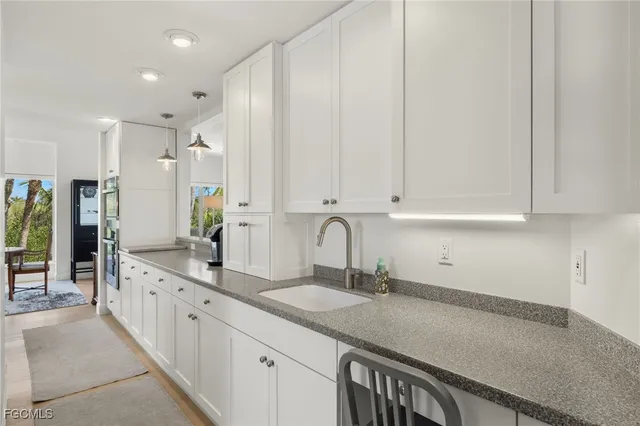 a kitchen with a stove a refrigerator and a sink