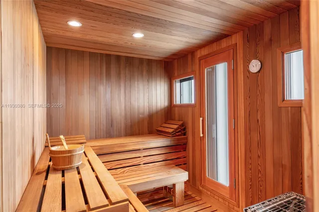 a bedroom with a balcony a bed and a flat screen tv