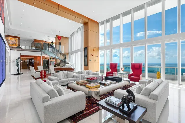 a living room filled with furniture and a large window