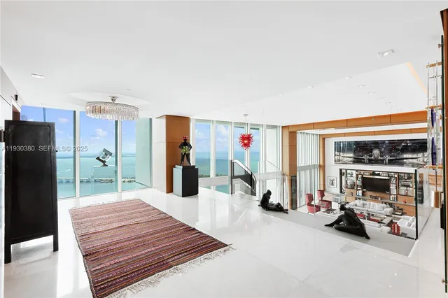 a kitchen with counter top space and living room view
