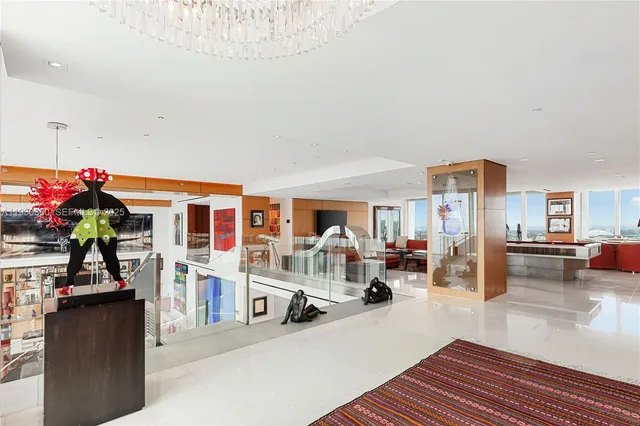 a kitchen with stainless steel appliances a sink a stove a refrigerator and cabinets