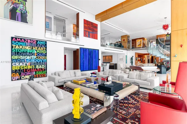 a living room with furniture and a floor to ceiling window