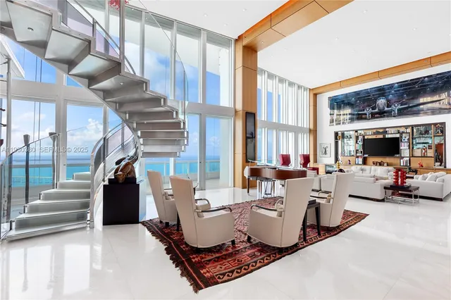 a living room with furniture a rug and a chandelier