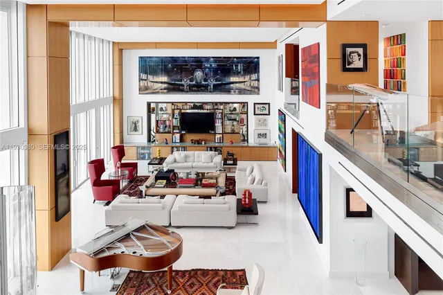 a view of living room filled with furniture and a rug