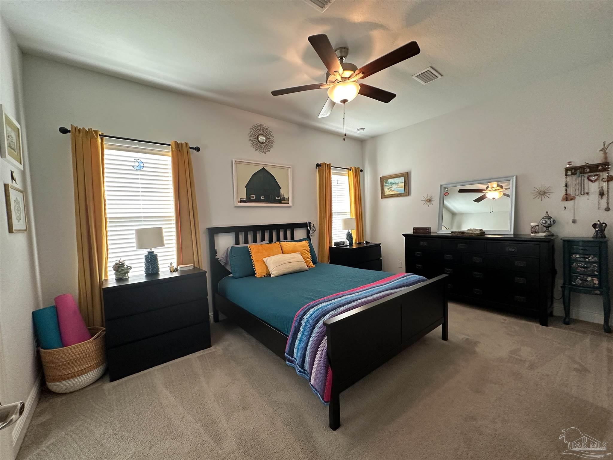 3613 Conley Drive Cantonment, FL 32533 - Photo 11 of 23 a bedroom with a bed and a chandelier
