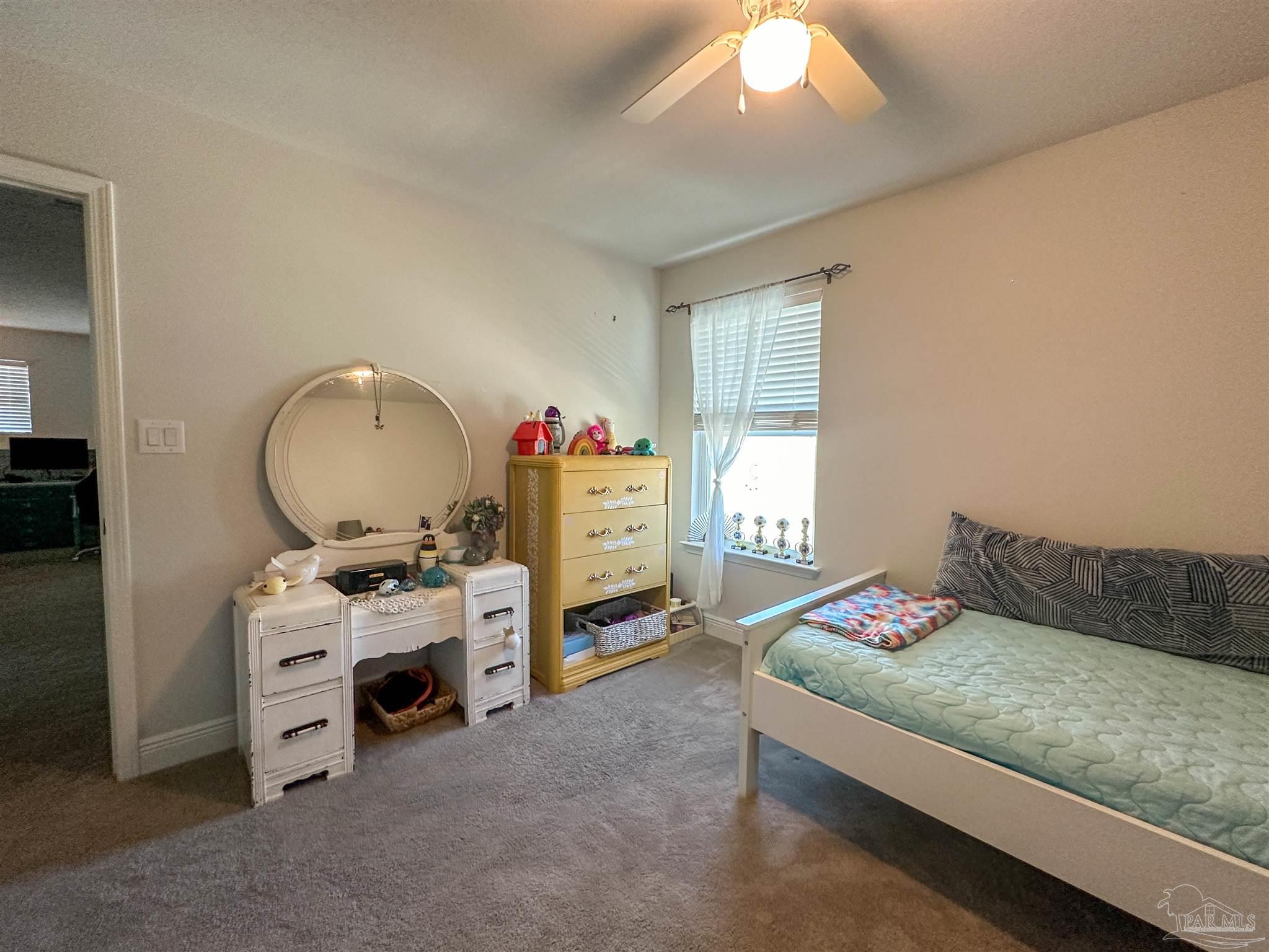 3613 Conley Drive Cantonment, FL 32533 - Photo 2 of 23 a bedroom with a bed and a chandelier