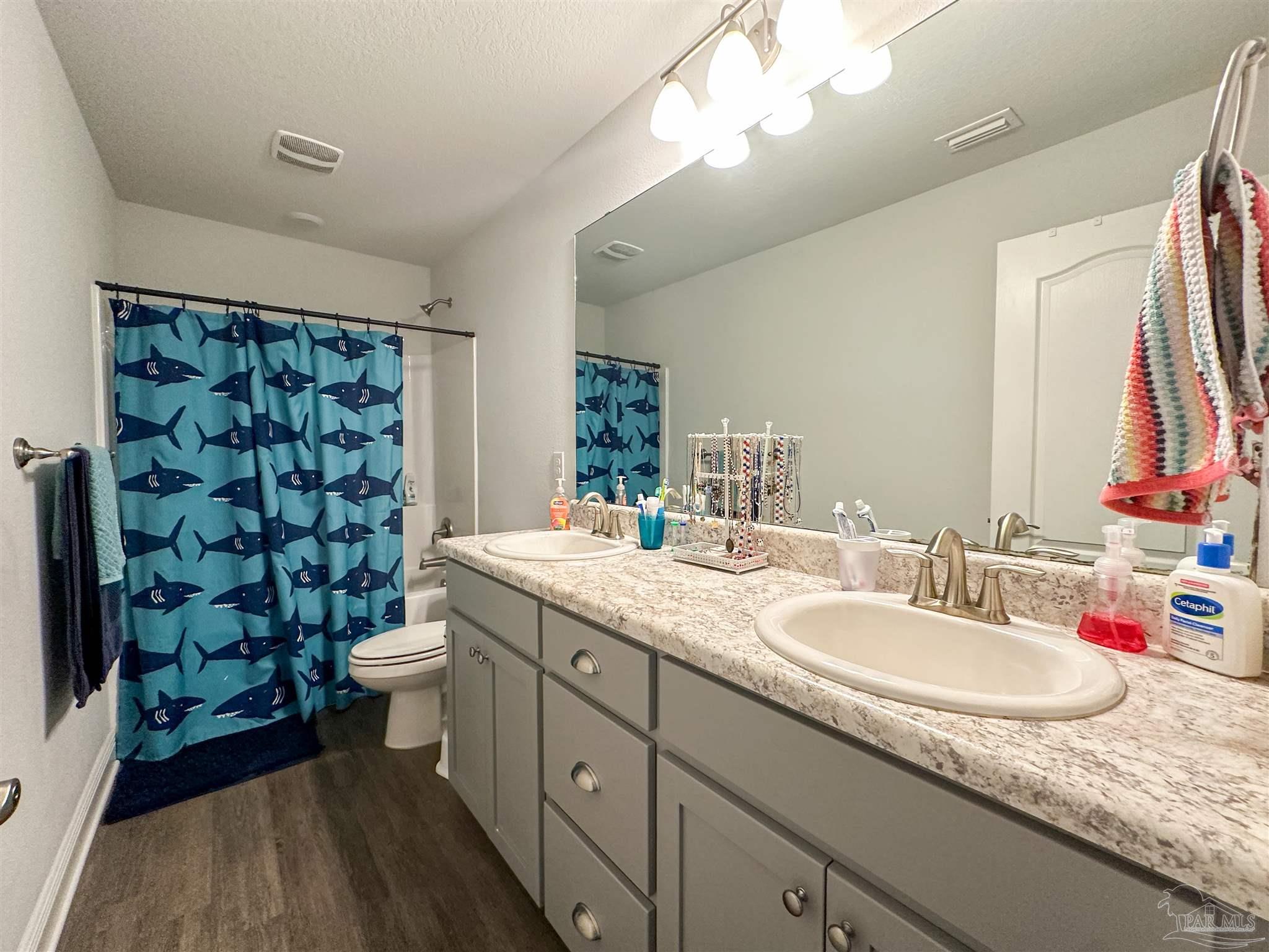 3613 Conley Drive Cantonment, FL 32533 - Photo 3 of 23 a bathroom with a granite countertop sink a toilet and shower
