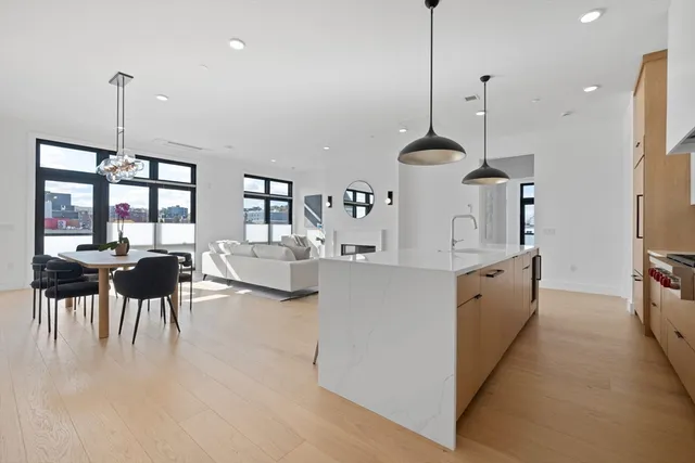 a very nice looking living room with a large window and wooden floor