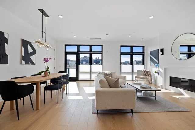 a living room with furniture fireplace and dining table