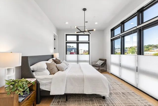 a bedroom with a large bed and a window